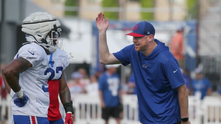 Bills offensive coordinator Joe Brady talks yardage with running backs Darrynton Evans and Ray Davis during day six of the Buffalo Bills training camp.