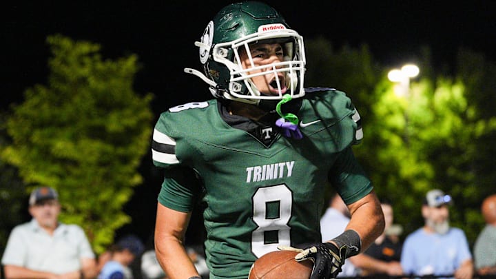 Trinity celebrates touchdown against visiting Frederick Douglass in the second half as the Rocks roll past the Broncos.