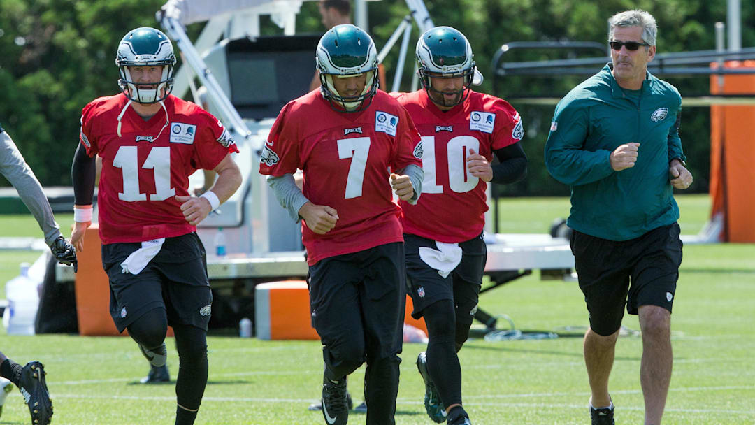 Jun 9, 2016; Philadelphia, PA, USA; Philadelphia Eagles quarterback Carson Wentz (11) and quarterback Sam Bradford (7) and quarterback Chase Daniel (10) and  offensive coordinator Frank Reich (right) during mini camp at NovaCare Complex. Mandatory Credit: Bill Streicher-Imagn Images