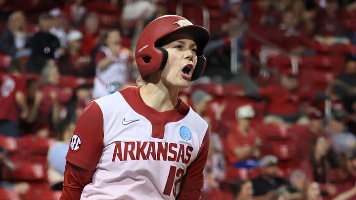 May 18, 2025; Fayetteville, AR, USA; Arkansas Razorbacks pinch runner Kasey Wood (13) celebrates after scoring during the game against the Oklahoma State Cowgirls at Bogle Park. Mandatory Credit: Nelson Chenault-Imagn Images