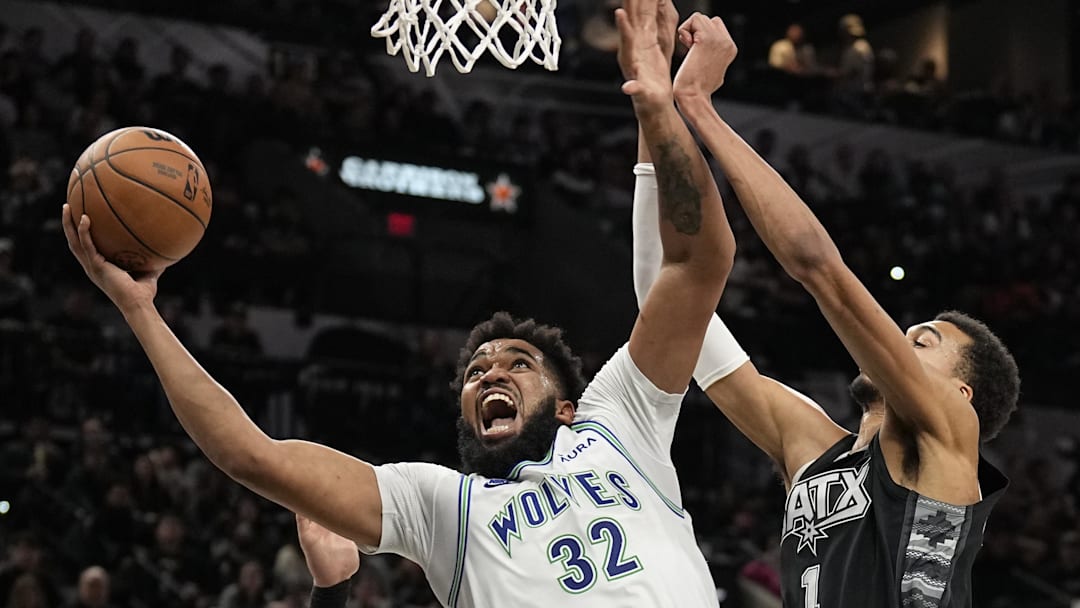Jan 27, 2024; San Antonio, Texas, USA; Minnesota Timberwolves center Karl-Anthony Towns (32) shoots over San Antonio Spurs forward Victor Wembanyama (1) during the second half at Frost Bank Center. 