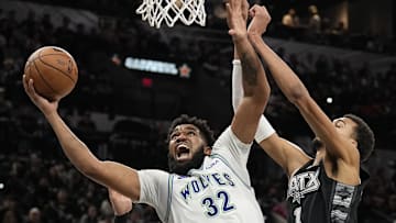 Jan 27, 2024; San Antonio, Texas, USA; Minnesota Timberwolves center Karl-Anthony Towns (32) shoots over San Antonio Spurs forward Victor Wembanyama (1) during the second half at Frost Bank Center. 