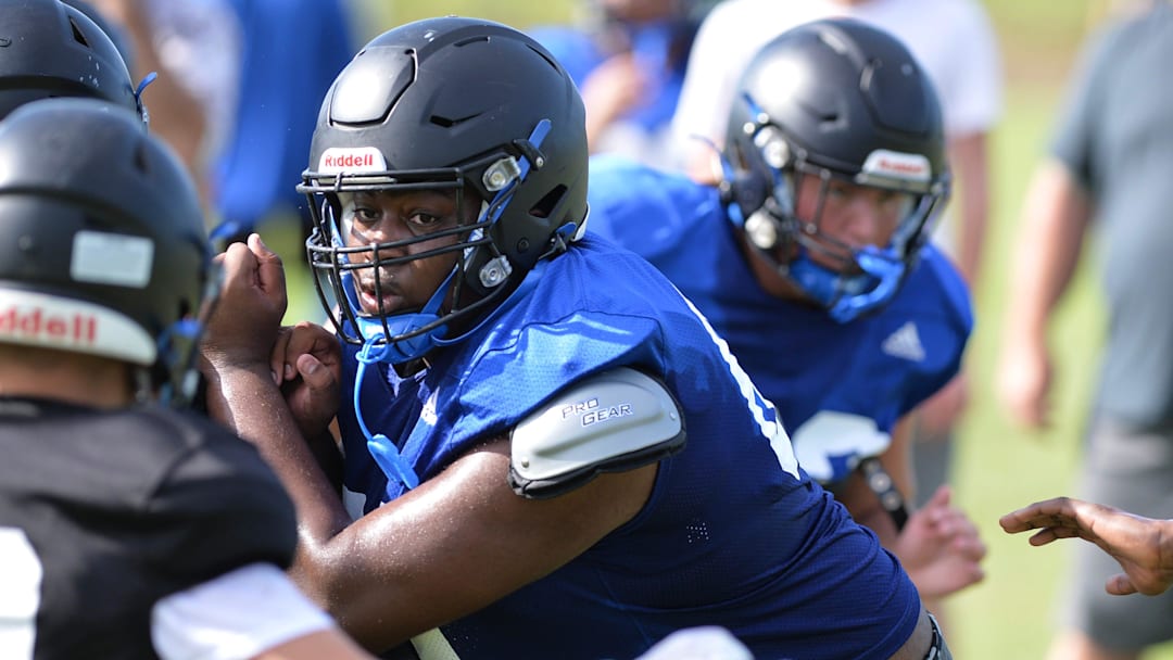 John Carroll HIgh School's offensive tackle Sean Tatum (center) runs a pay during a team practice on Thursday, Aug. 1, 2024, at the school's practice field in Fort Pierce.