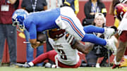 Sep 7, 2025; Landover, Maryland, USA; New York Giants quarterback Russell Wilson (3) fumbles the ball against Washington Commanders safety Will Harris (3) during the first quarter at Northwest Stadium.