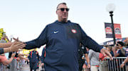 Sep 27, 2025; Champaign, Illinois, USA;  Illinois Fighting Illini head coach Bret Bielema leads his team down the Illini Walk before an NCAA football game with the Southern California Trojans at Memorial Stadium. Mandatory Credit: Ron Johnson-Imagn Images