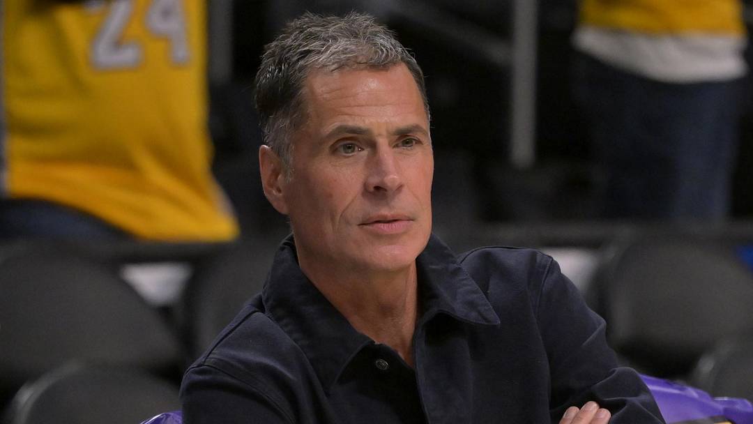 Nov 21, 2024; Los Angeles, California, USA;  Los Angeles Lakers general manager Rob Pelinka, right, talks with Leroy Sims, director of player performance & health, prior to the game against the Orlando Magic at Crypto.com Arena. Mandatory Credit: Jayne Kamin-Oncea-Imagn Images