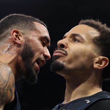Dec 21, 2024; Orlando, Florida, USA; Orlando Magic guard Trevelin Queen (12) and guard Cole Anthony (50) celebrates after a called foul against the Miami Heat in the fourth quarter at Kia Center. Mandatory Credit: Nathan Ray Seebeck-Imagn Images