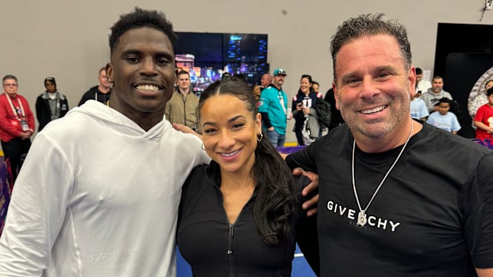 Miami Dolphins' Tyreek Hill poses with wife Keeta Vaccaro and Hollywood director Randall Emmett at the Franklin Pickleball Experience in Las Vegas.