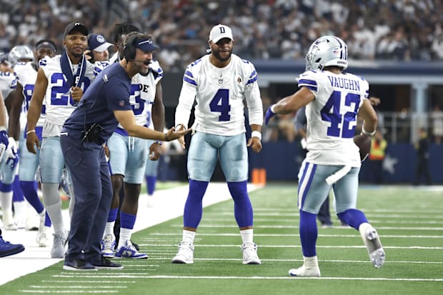 Brian Schottenheimer, Dak Prescott, and Deuce Vaughn celebrate a touchdown against the Jacksonville Jaguars. 