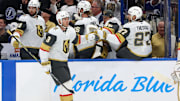 Oct 17, 2024; Tampa, Florida, USA; Vegas Golden Knights defenseman Brayden McNabb (3) is congratulated by Vegas Golden Knights defenseman Shea Theodore (27) after he scored a goal against the Tampa Bay Lightning during the first period at Amalie Arena. Mandatory Credit: Kim Klement Neitzel-Imagn Images