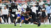  Boise State quarterback Maddux Madsen is brought down by South Florida linebacker Jhalyn Shuler.