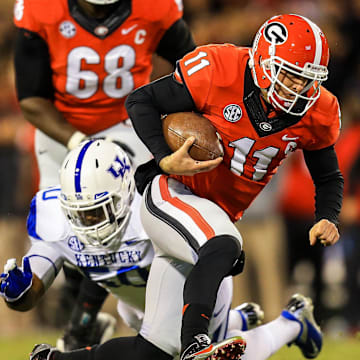 Nov 23, 2013; Athens, GA, USA; Georgia Bulldogs quarterback Aaron Murray (11) is tackled on a run by Kentucky Wildcats defensive lineman Mike Douglas (50) in the first half at Sanford Stadium. 