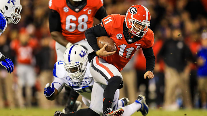 Nov 23, 2013; Athens, GA, USA; Georgia Bulldogs quarterback Aaron Murray (11) is tackled on a run by Kentucky Wildcats defensive lineman Mike Douglas (50) in the first half at Sanford Stadium. 