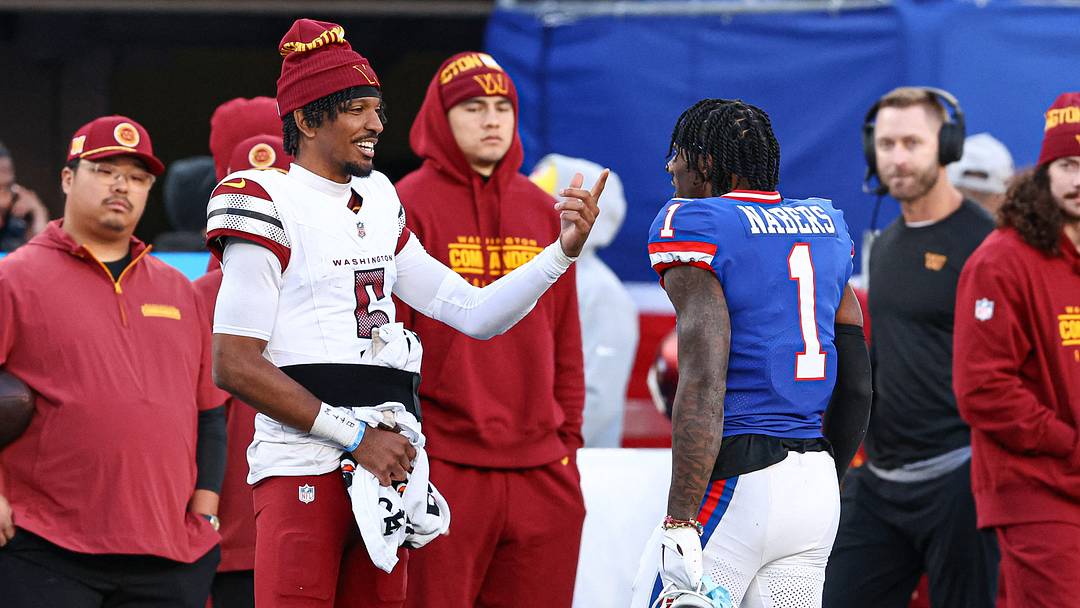 Nov 3, 2024; East Rutherford, New Jersey, USA; New York Giants wide receiver Malik Nabers (1) talks with Washington Commanders quarterback Jayden Daniels (5) during a time out during the second half at MetLife Stadium. Mandatory Credit: Vincent Carchietta-Imagn Images