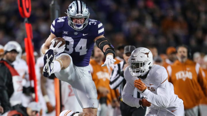 Nov 5, 2022; Manhattan, Kansas, USA; Kansas State Wildcats tight end Ben Sinnott (34) jumps over Texas Longhorns defensive back Jerrin Thompson (28) during the first quarter at Bill Snyder Family Football Stadium. Mandatory Credit: Scott Sewell-USA TODAY Sports