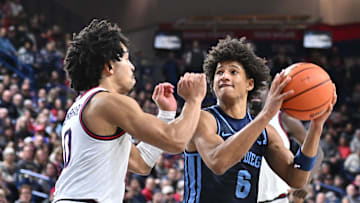 Jan 8, 2025; Spokane, Washington, USA; San Diego Toreros guard Tony Duckett (6) drives against Gonzaga Bulldogs guard Ryan Nembhard (0) in the second half at McCarthey Athletic Center. Gonzaga Bulldogs won 93-80. Mandatory Credit: James Snook-Imagn Images