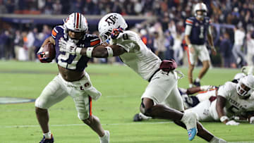 Nov 23, 2024; Auburn, Alabama, USA;  Auburn Tigers running back Jarquez Hunter (27) is chased by Texas A&M Aggies linebacker Scooby Williams (0) during the fourth quarter at Jordan-Hare Stadium. Mandatory Credit: John Reed-Imagn Images