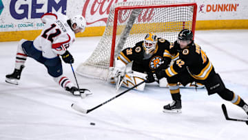 Providence Bruins goalie Michael DiPietro and defender Frederic Brunet deflect the puck from Thunderbird Dylan Peterson away from the Providence goal.