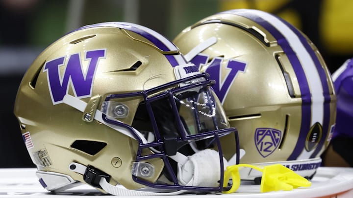 Jan 1, 2024; New Orleans, LA, USA; Washington Huskies players' helmets rest on a cooler on the bench against the Texas Longhorns in the 2024 Sugar Bowl college football playoff semifinal game at Caesars Superdome. Mandatory Credit: Geoff Burke-Imagn Images