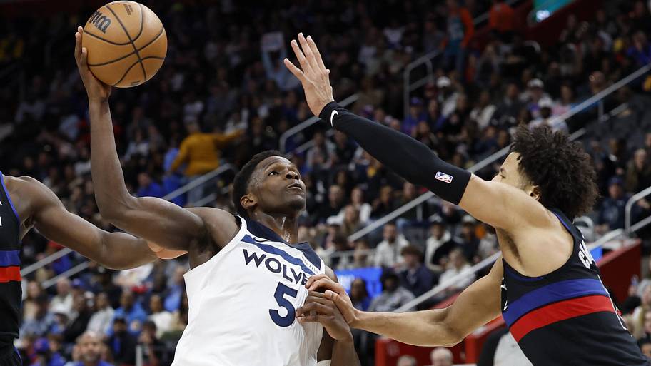 Minnesota Timberwolves guard Anthony Edwards goes to the basket on Detroit Pistons guard Cade Cunningham.