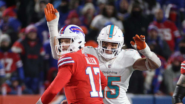 Bills quarterback Josh Allen is about to fumble the ball as he is hit from behind by Miami   s Jaelan Phillips.