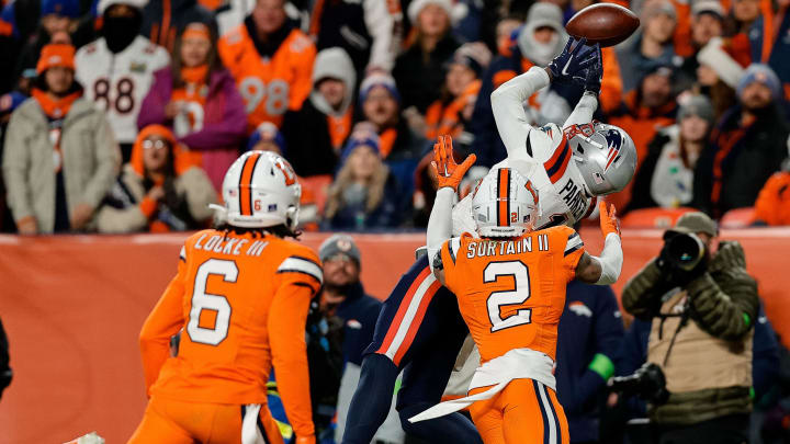 Dec 24, 2023; Denver, Colorado, USA; New England Patriots wide receiver DeVante Parker (1) is unable to pull in a pass against Denver Broncos cornerback Pat Surtain II (2) as safety P.J. Locke (6) defends in the second quarter at Empower Field at Mile High. 