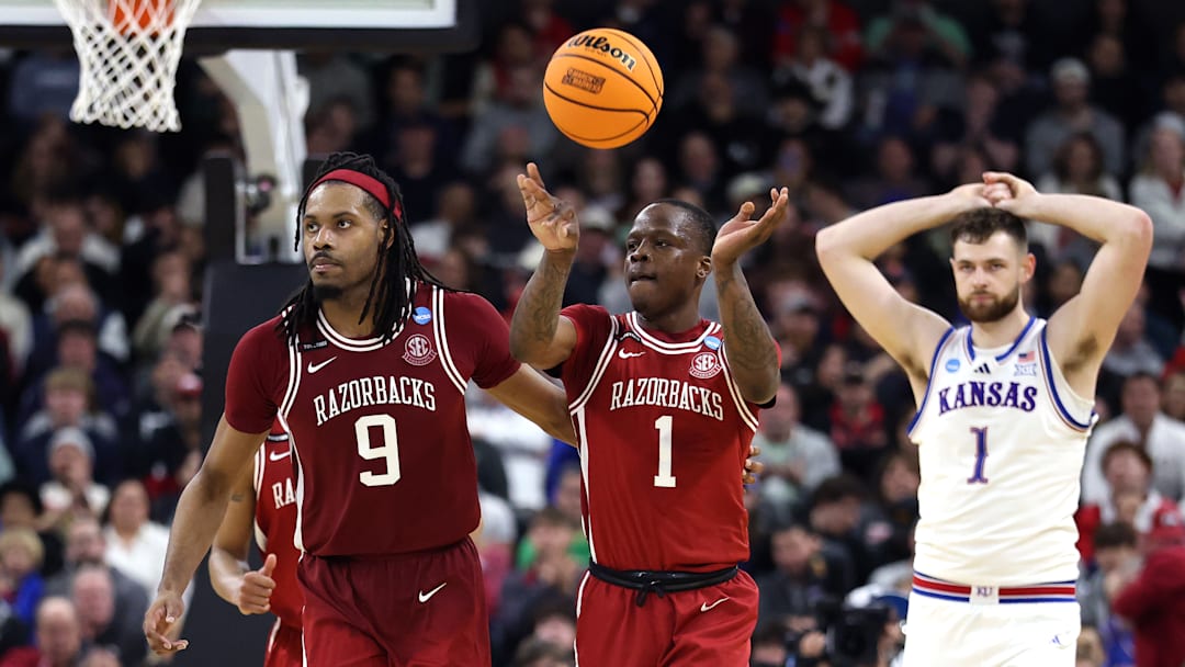 Arkansas Razorback seniors Jonas Aidoo (9) and Johnell Davis (1) head up court during the final seconds of Thursday's first-round win over the Kansas Jayhawks. 