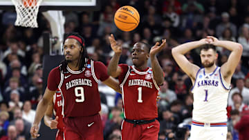 Arkansas Razorback seniors Jonas Aidoo (9) and Johnell Davis (1) head up court during the final seconds of Thursday's first-round win over the Kansas Jayhawks. 