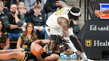 Jan 11, 2025; Columbia, Missouri, USA; Vanderbilt Commodores forward Devin McGlockton (99) and Missouri Tigers guard Mark Mitchell (25) scramble for a loose ball during the second half at Mizzou Arena. Mandatory Credit: Denny Medley-Imagn Images