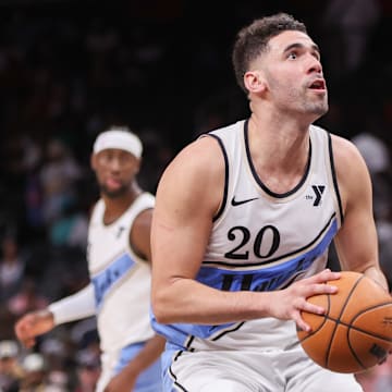 Mar 23, 2025; Atlanta, Georgia, USA; Atlanta Hawks forward Georges Niang (20) drives to the basket against the Philadelphia 76ers in the fourth quarter at State Farm Arena. Mandatory Credit: Brett Davis-Imagn Images
