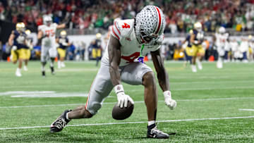 Jan 20, 2025; Atlanta, GA, USA; Ohio State Buckeyes wide receiver Jeremiah Smith (4) celebrates a play against the Notre Dame Fighting Irish during the CFP National Championship college football game at Mercedes-Benz Stadium. Mandatory Credit: Mark J. Rebilas-Imagn Images