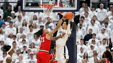 Penn State Nittany Lions forward Yanic Konan Niederhauser (14) grabs the rebound as Ohio State Buckeyes forward Devin Royal (21) defends during the first half at Rec Hall.