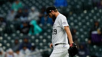 May 25, 2025; Denver, Colorado, USA; Colorado Rockies relief pitcher Jake Bird (59) walks to the mound as rain falls in the fifth inning against the New York Yankees at Coors Field. Mandatory Credit: Isaiah J. Downing-Imagn Images