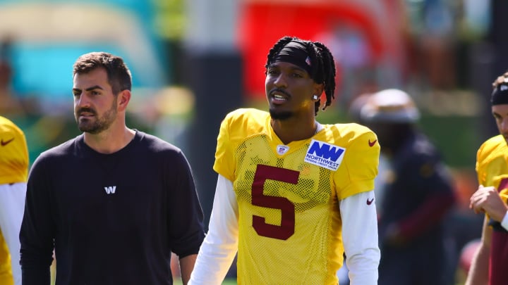 Aug 15, 2024; Miami Gardens, FL, USA; Washington Commanders quarterback Jayden Daniels (5) looks on during joint practice with the Miami Dolphins at Baptist Health Training Complex. Mandatory Credit: Sam Navarro-USA TODAY Sports