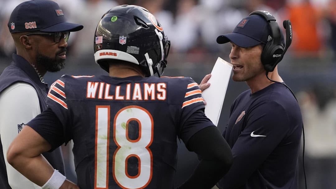 Sep 21, 2025; Chicago, Illinois, USA; Chicago Bears head coach Ben Johnson talks with quarterback Caleb Williams (18) against the Dallas Cowboys during the second half at Soldier Field. Mandatory Credit: David Banks-Imagn Images