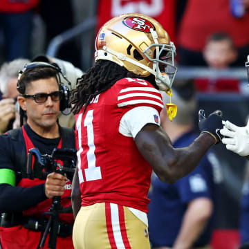 Dec 17, 2023; Glendale, Arizona, USA; San Francisco 49ers wide receiver Deebo Samuel (19) celebrates with wide receiver Brandon Aiyuk (11) after scoring a touchdown during the first quarter against the Arizona Cardinals at State Farm Stadium. Mandatory Credit: Mark J. Rebilas-USA TODAY Sports