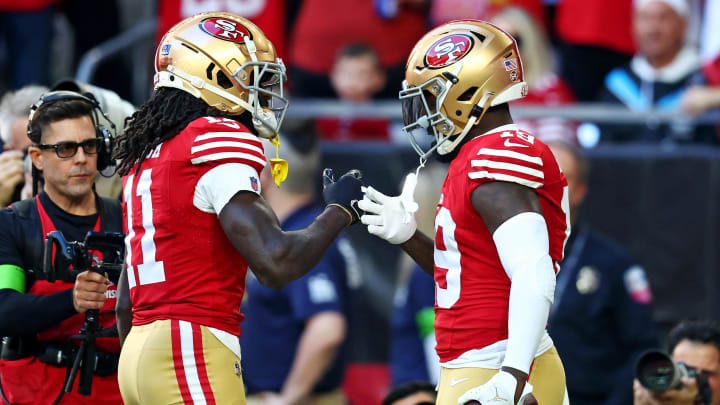 Dec 17, 2023; Glendale, Arizona, USA; San Francisco 49ers wide receiver Deebo Samuel (19) celebrates with wide receiver Brandon Aiyuk (11) after scoring a touchdown during the first quarter against the Arizona Cardinals at State Farm Stadium. Mandatory Credit: Mark J. Rebilas-USA TODAY Sports