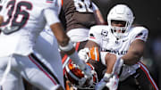 Sep 6, 2025; Cincinnati, Ohio, USA; Cincinnati Bearcats defensive lineman Dontay Corleone (2) tackles Bowling Green Falcons running back Kaderris Roberts (0) in the first half at Nippert Stadium. Mandatory Credit: Aaron Doster-Imagn Images