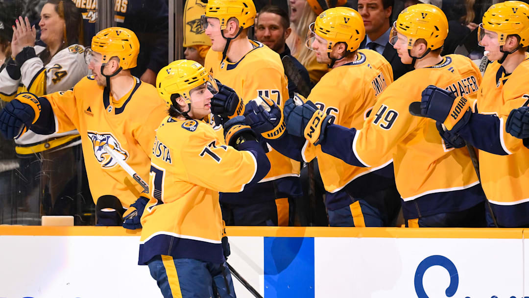 Feb 4, 2026; Nashville, Tennessee, USA;  Nashville Predators right wing Luke Evangelista (77) celebrates with his teammates after scoring a goal against the Minnesota Wild during the second period at Bridgestone Arena. Mandatory Credit: Steve Roberts-Imagn Images