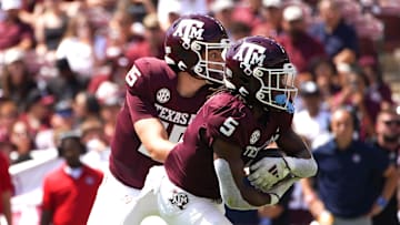 Sep 7, 2024; College Station, Texas, USA; Texas A&M Aggies quarterback Conner Weigman (15) hands the ball to running back Amari Daniels (5) during the first quarter against the McNeese State Cowboys at Kyle Field. Mandatory Credit: Dustin Safranek-Imagn Images