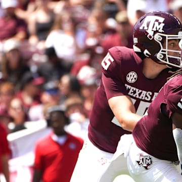 Sep 7, 2024; College Station, Texas, USA; Texas A&M Aggies quarterback Conner Weigman (15) hands the ball to running back Amari Daniels (5) during the first quarter against the McNeese State Cowboys at Kyle Field. Mandatory Credit: Dustin Safranek-Imagn Images