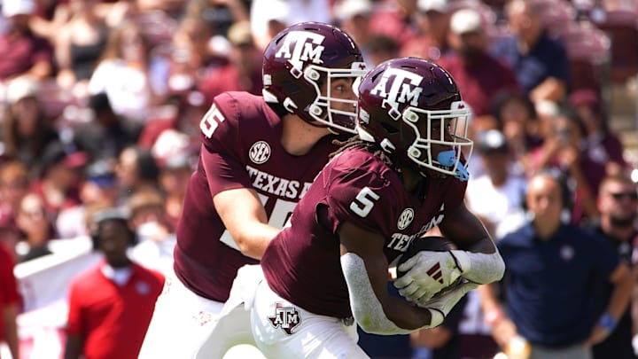 Sep 7, 2024; College Station, Texas, USA; Texas A&M Aggies quarterback Conner Weigman (15) hands the ball to running back Amari Daniels (5) during the first quarter against the McNeese State Cowboys at Kyle Field. Mandatory Credit: Dustin Safranek-Imagn Images