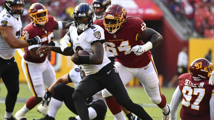 Baltimore Ravens quarterback Lamar Jackson (8) is sacked by Washington Football Team defensive end David Bada (64) 