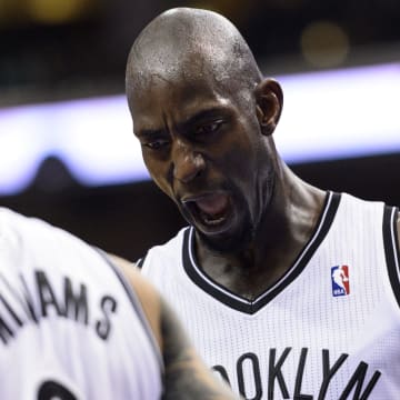 Apr 5, 2014; Philadelphia, PA, USA; Brooklyn Nets center Kevin Garnett (2) celebrates with guard Deron Williams (8) during the third quarter against the Philadelphia 76ers at the Wells Fargo Center. The Nets defeated the Sixers 105-101. Mandatory Credit: Howard Smith-USA TODAY Sports