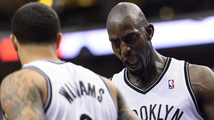 Apr 5, 2014; Philadelphia, PA, USA; Brooklyn Nets center Kevin Garnett (2) celebrates with guard Deron Williams (8) during the third quarter against the Philadelphia 76ers at the Wells Fargo Center. The Nets defeated the Sixers 105-101. Mandatory Credit: Howard Smith-USA TODAY Sports