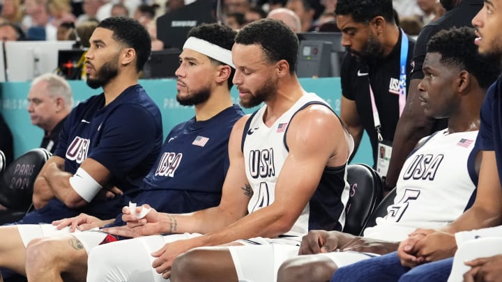 Aug 8, 2024; Paris, France; (L-R) United States small forward Jayson Tatum (10), guard Devin Booker (15), shooting guard Stephen Curry (4) and guard Anthony Edwards (5) look on from the bench during the first half against Serbia in a men's basketball semifinal game during the Paris 2024 Olympic Summer Games at Accor Arena. Mandatory Credit: Rob Schumacher-USA TODAY Sports