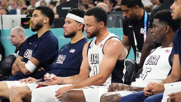 Aug 8, 2024; Paris, France; (L-R) United States small forward Jayson Tatum (10), guard Devin Booker (15), shooting guard Stephen Curry (4) and guard Anthony Edwards (5) look on from the bench during the first half against Serbia in a men's basketball semifinal game during the Paris 2024 Olympic Summer Games at Accor Arena. Mandatory Credit: Rob Schumacher-USA TODAY Sports