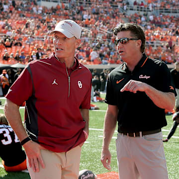 Oklahoma State coach Mike Gundy, right, and Oklahoma coach Brent Venables talk before a Bedlam college football game between the Oklahoma State University Cowboys (OSU) and the University of Oklahoma Sooners (OU) at Boone Pickens Stadium in Stillwater, Okla., Saturday, Nov. 4, 2023.
