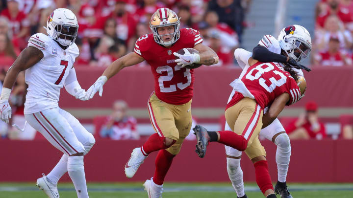 Oct 1, 2023; Santa Clara, California, USA; San Francisco 49ers running back Christian McCaffrey (23) runs with the ball past Arizona Cardinals linebacker Kyzir White (7) during the fourth quarter at Levi's Stadium. Mandatory Credit: Sergio Estrada-USA TODAY Sports