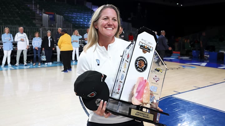 Nov 25, 2024; Paradise Island, Bahamas, BHS; North Carolina Tar Heels head coach Courtney Banghart celebrates with the Battle4Atlantis trophy after the game against the Indiana Hoosiers at the Atlantis Resort. Mandatory Credit: Kevin Jairaj-Imagn Images